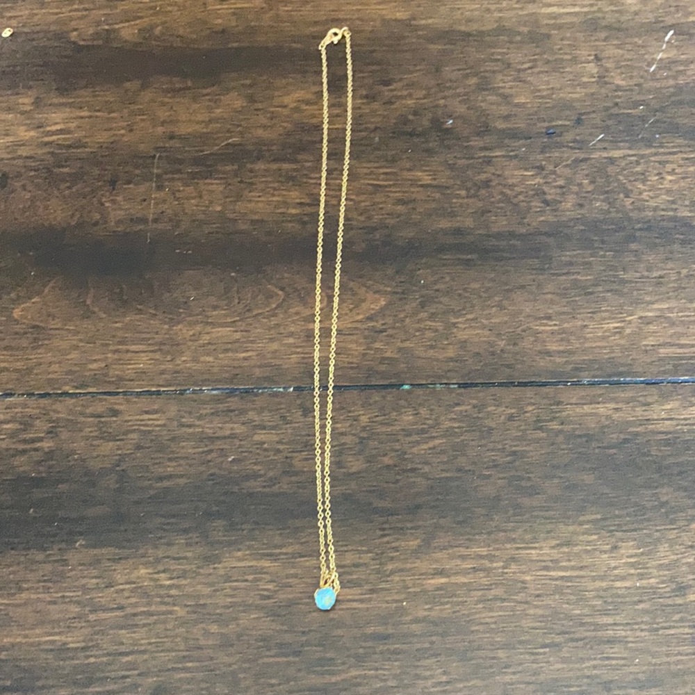 I am selling a gold necklace with a blue stone